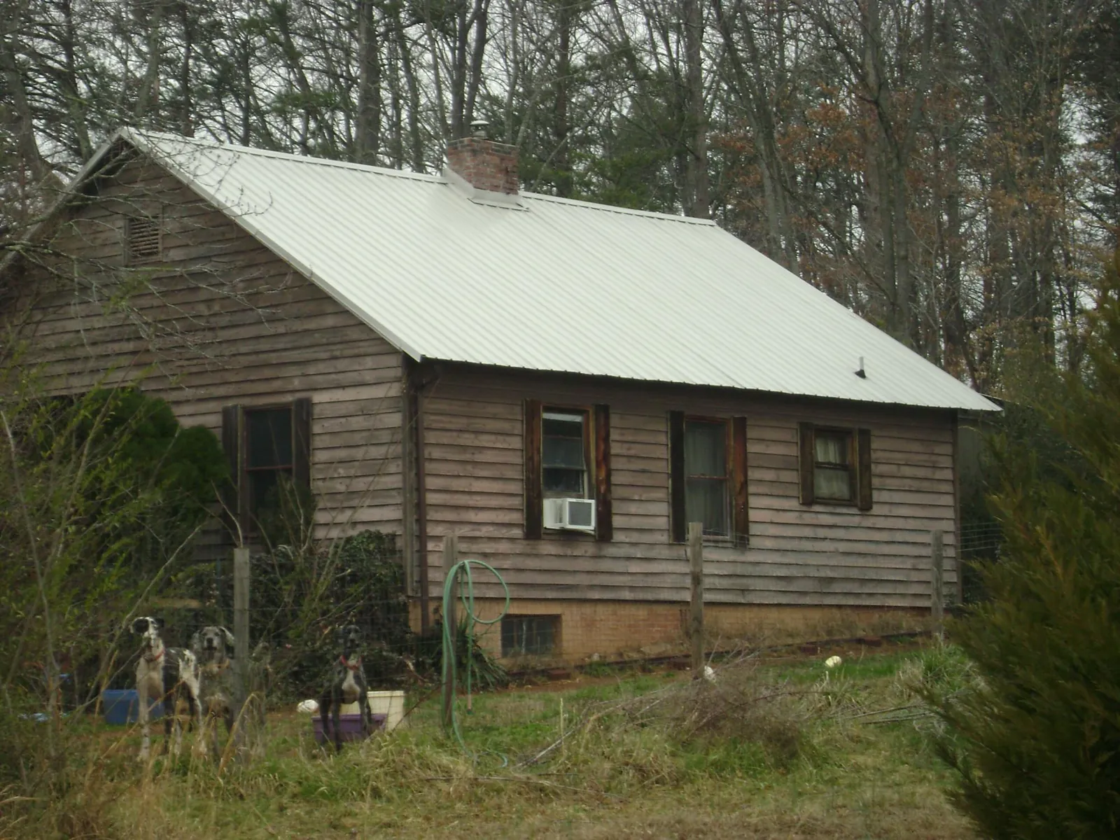 White metal roof on an old wood sided farmhouse, from a Metal Roof Installation job in La Follette